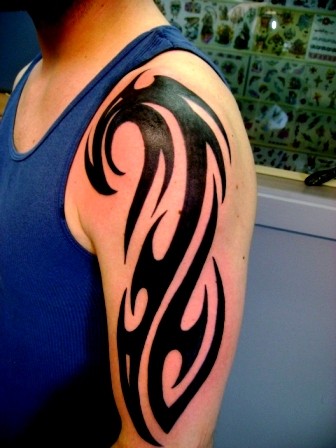 trendy tribal tattoo on arm man